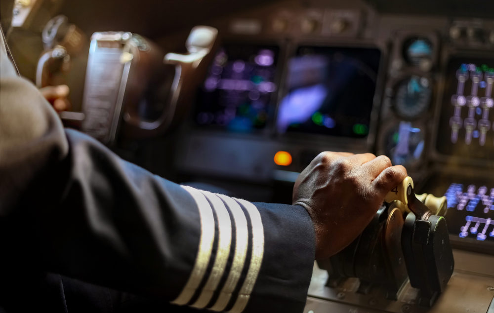 Close-up of a pilot's hand on an airplane's throttle control