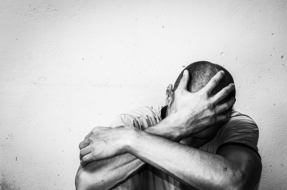 Black and white photo of a man in distress