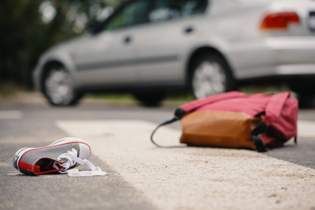 Child's shoe and backpack after a car collision