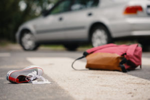 Child's shoe and backpack after a car collision