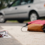 Child's shoe and backpack after a car collision