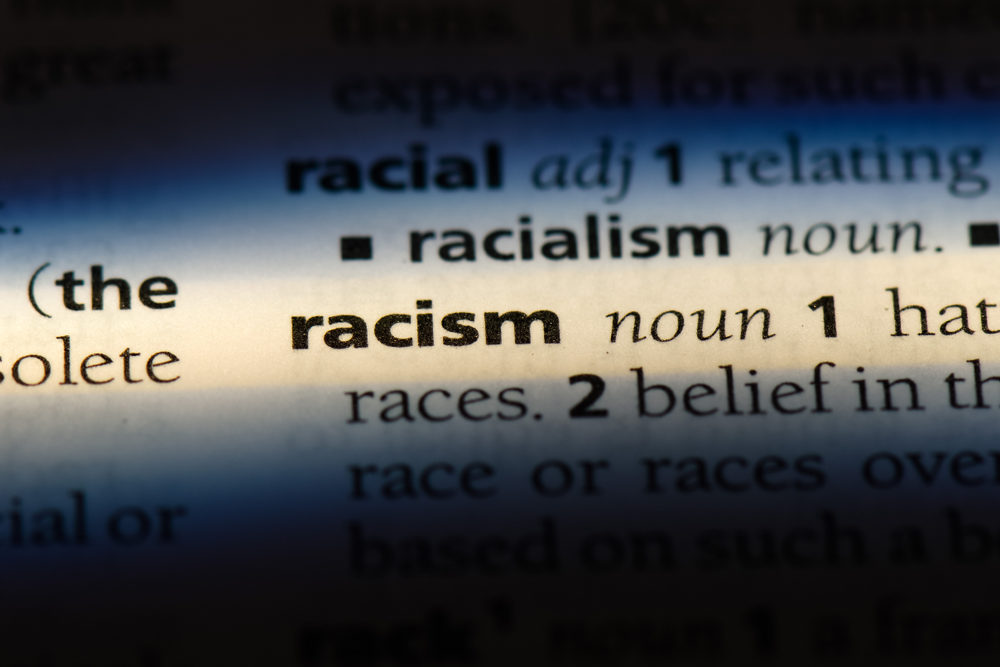 The word "racism" highlighted in a dictionary