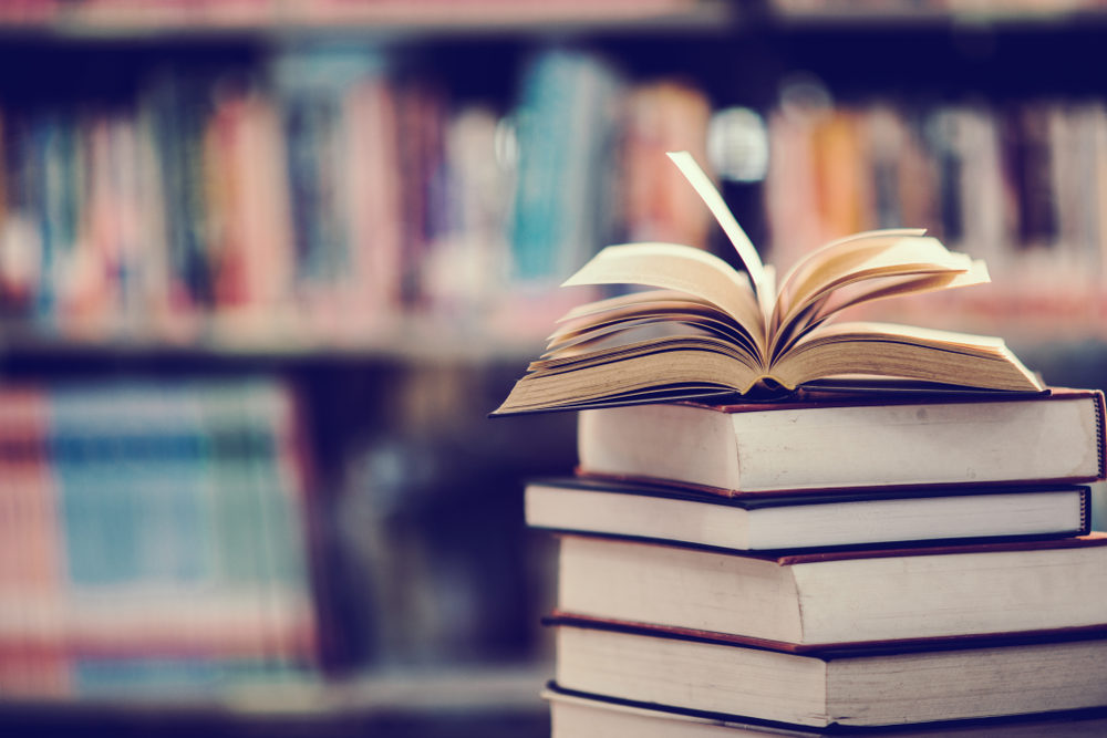 Randallstown High School Teacher, Carlos Arroyo, Charged With Two Felony Counts of Child Sex Abuse A stack of books, with an open textbox at the top