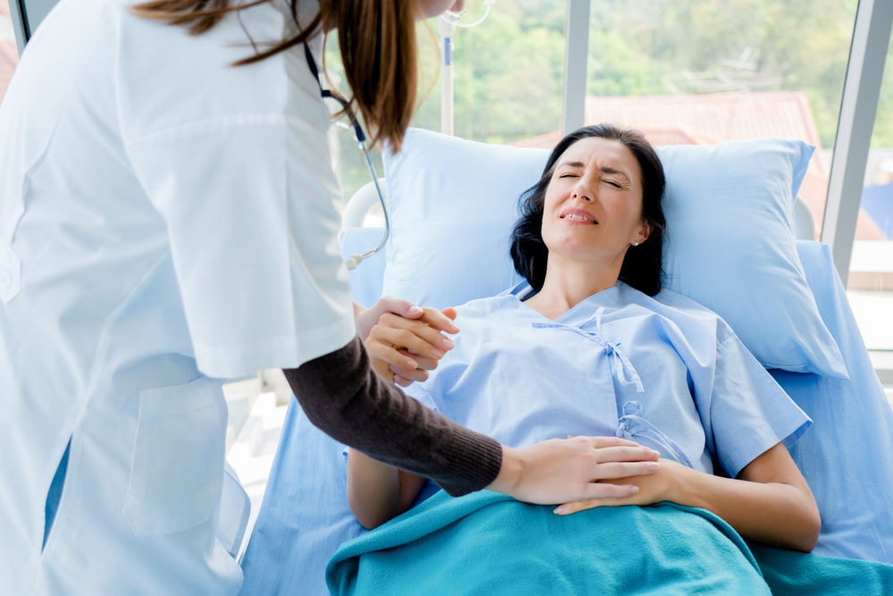 A doctor holding a female patient's hands