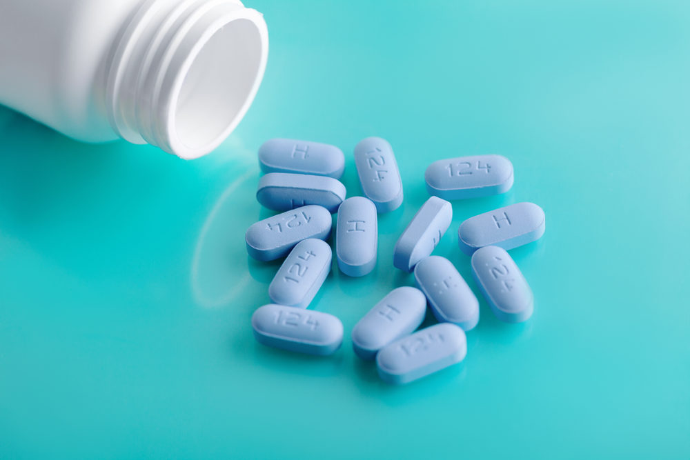 Pre-Exposure Prophylaxis (PrEP) pills spilled from an open bottle