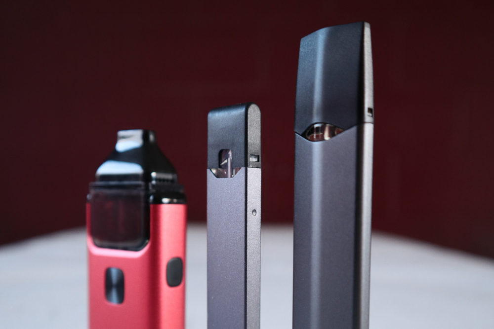 Three different vape pens standing side-by-side