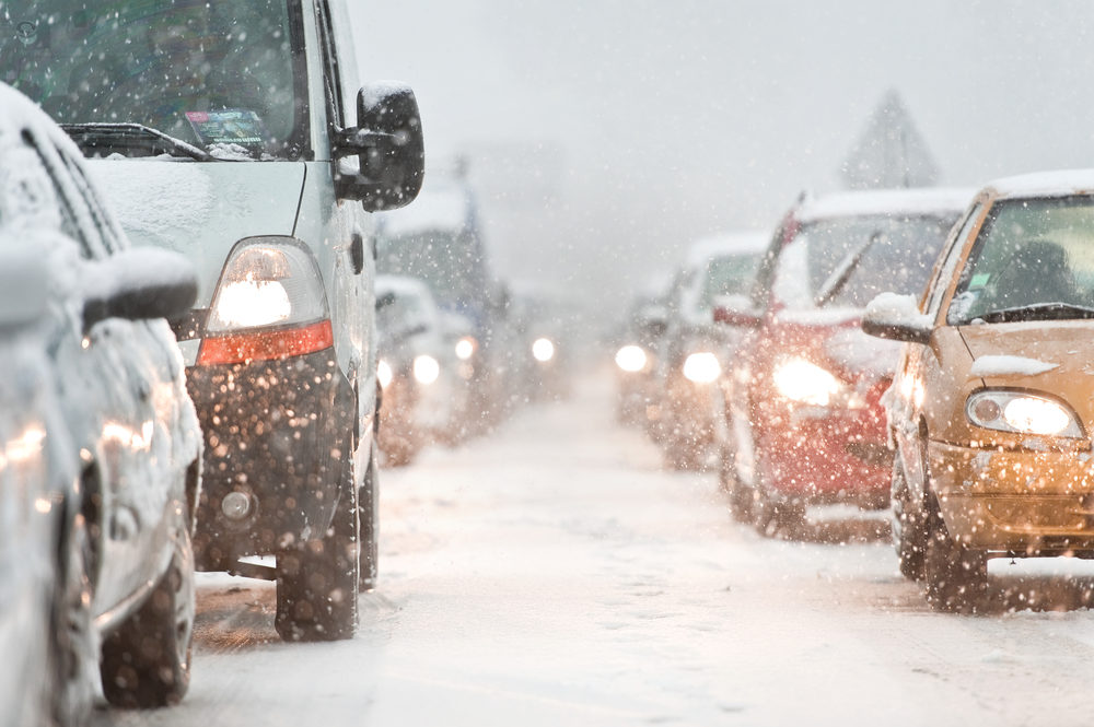 Cars lined up in a traffic jam during a snowstorm