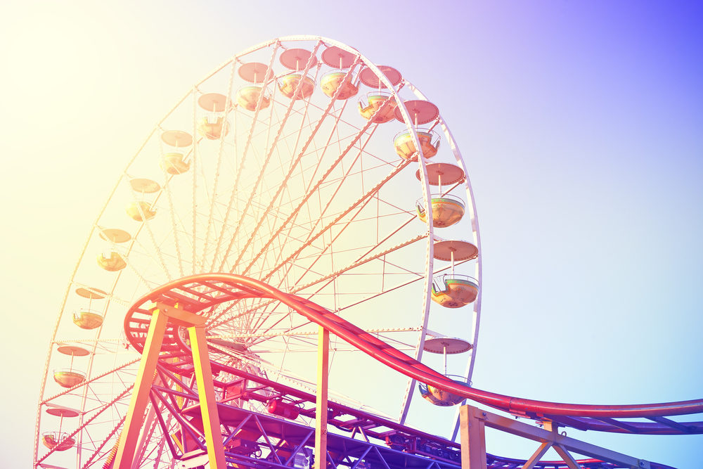 A ferris wheel and a roller coaster at an amusement park