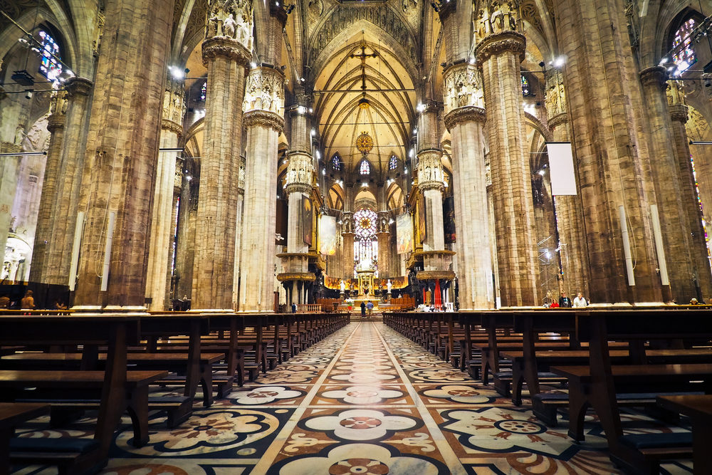 Two More Catholic Dioceses File for Bankruptcy Protection Interior photo of a large, ornate church with tiled floor and many pews