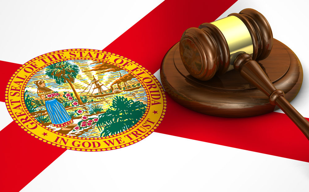 Florida Legislature May Limit Business Lawsuits Stemming from COVID-19 Pandemic A gavel sits atop the Floridian flag