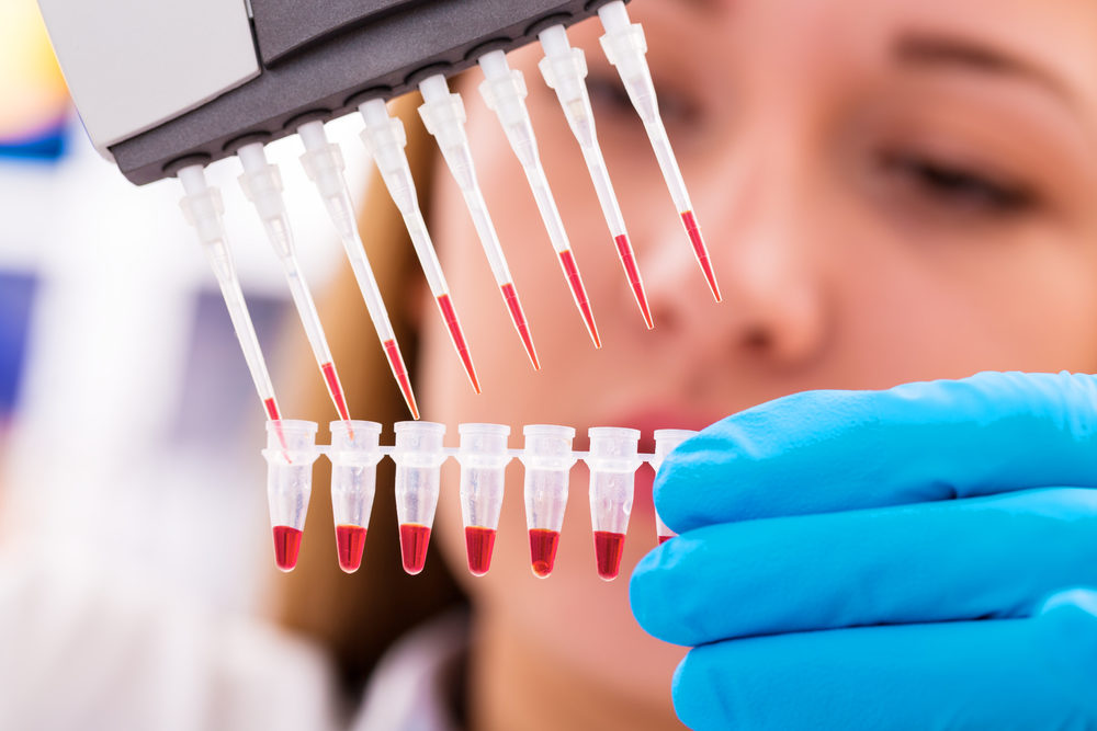 A female scientest extracting cell samples in a laboratory