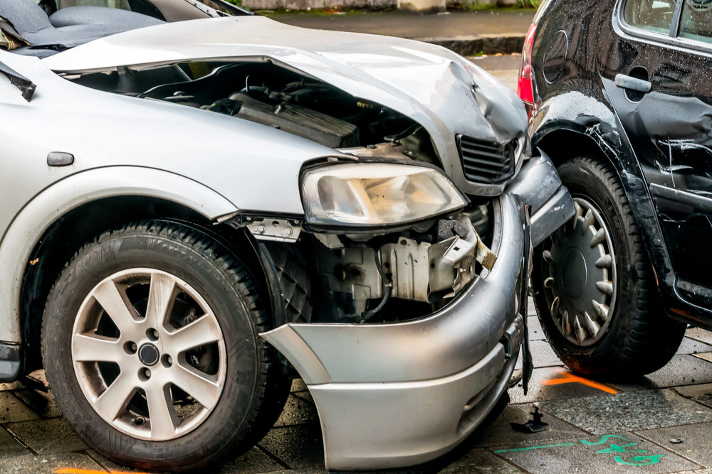 The crumpled front-end of a car after a traffic collision