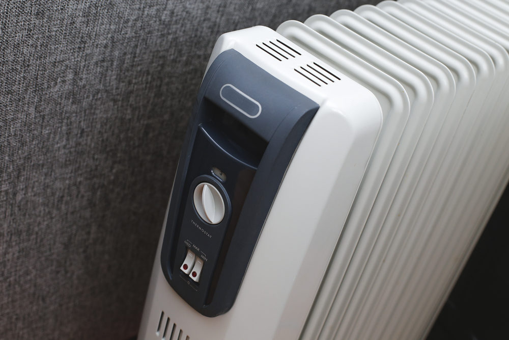 White radiator-style electric heater with control panel