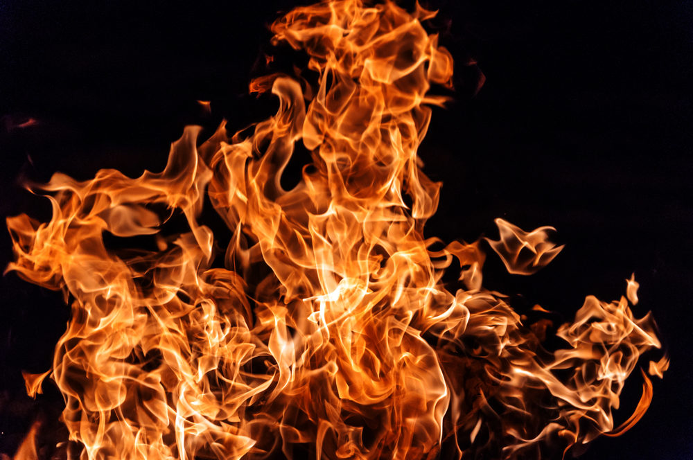 Flames dance against a black background