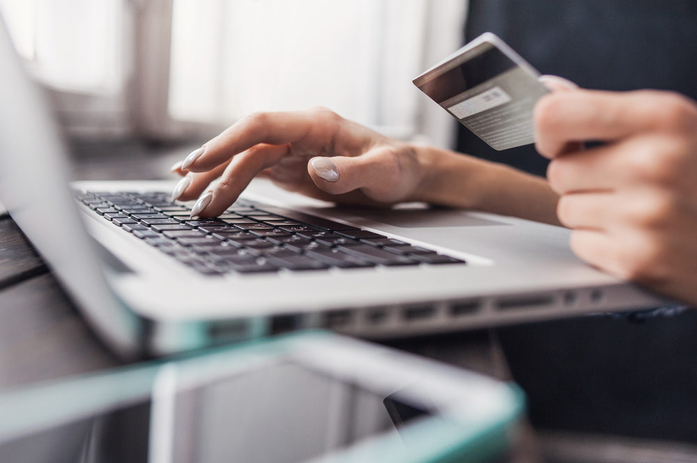 A woman enter her credit card number online