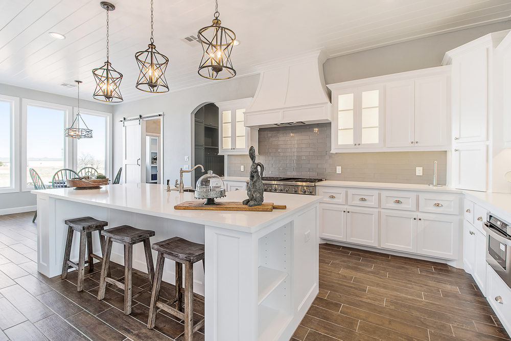 A bright white, modern kitchen in a luxury home