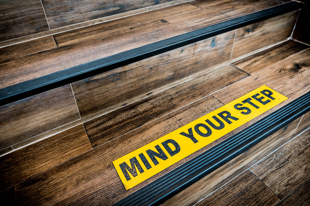 Mind Your Step sign on wooden staircase