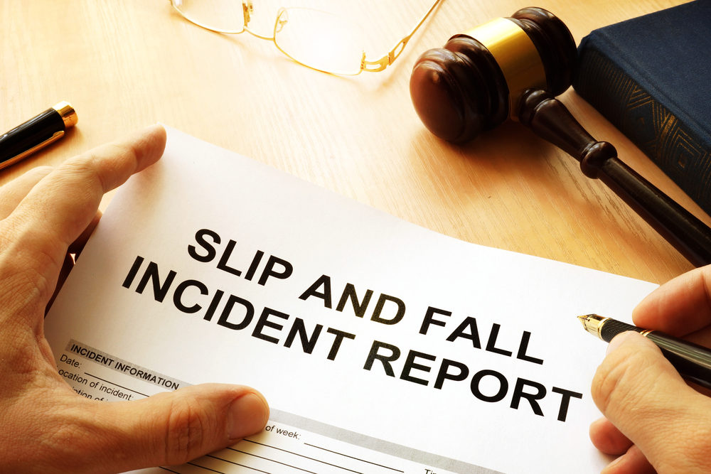 A SLIP AND FALL INCIDENT REPORT being filled out by an attorney