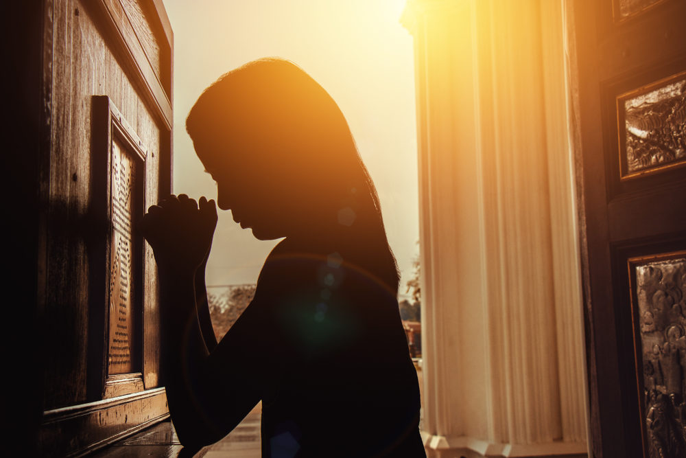 Former Discover Church Youth Pastor, Kevin Madden, Accused of Sending Nude Pictures to Two Girls silhouette of young woman kneeling and praying in church with sunlight shining