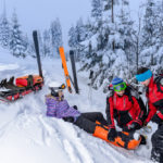 Ski patrol team rescue woman skier with broken leg