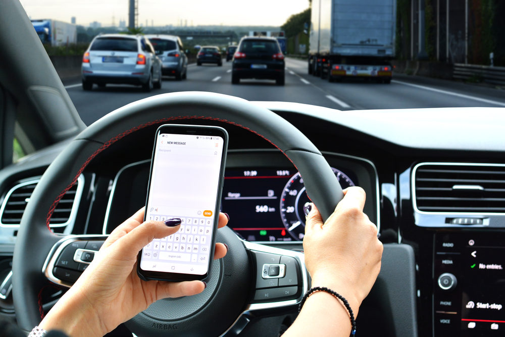 Louisiana Leads States in Distracted Driving Crashes Woman sending message from a smartphone while driving a car