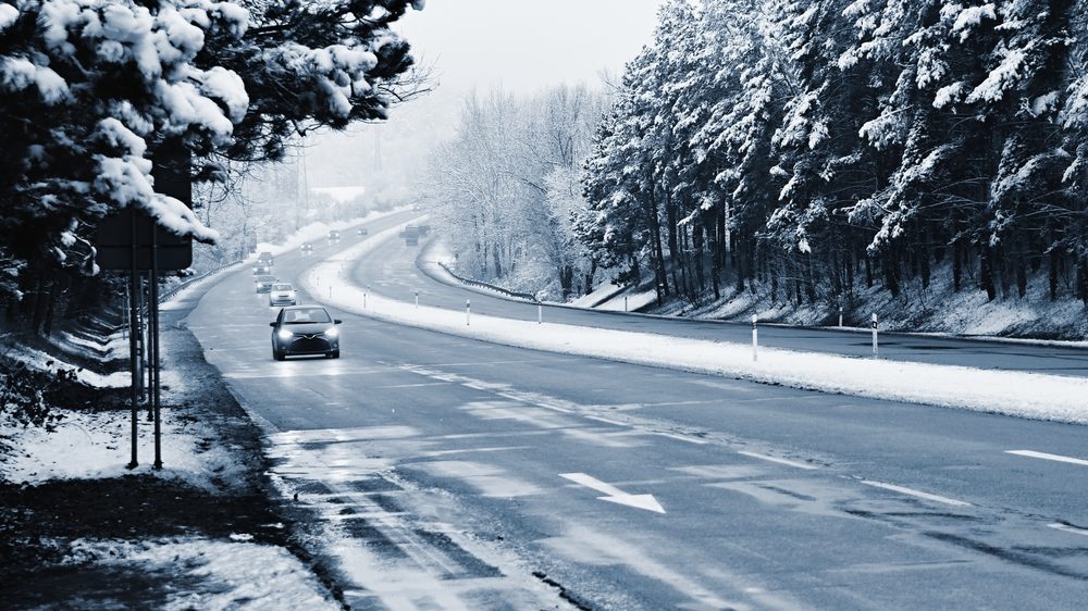 Cars on winter road with snow.