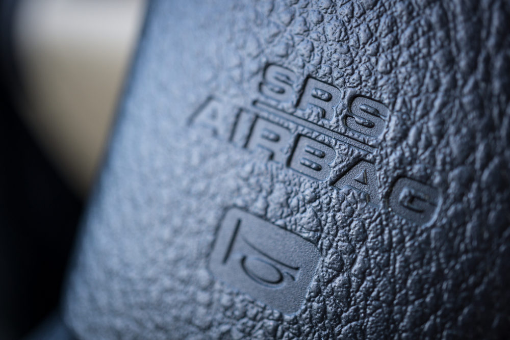 Close up image of the airbag and horn signs on the steering wheel of a car