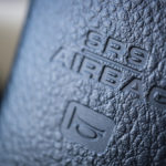 Close up image of the airbag and horn signs on the steering wheel of a car