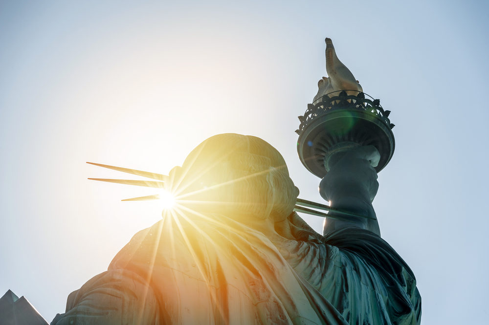 The Statue of Liberty bathed in the light of the rising sun