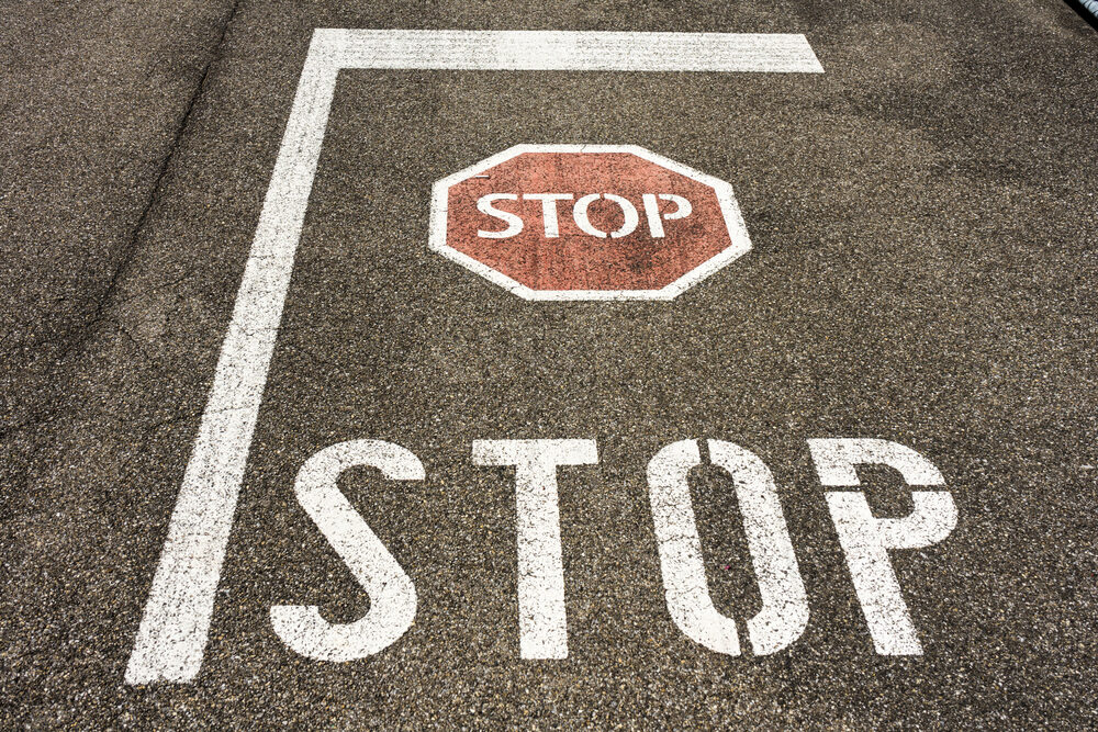 stop sign on city asphalt floor with symbol