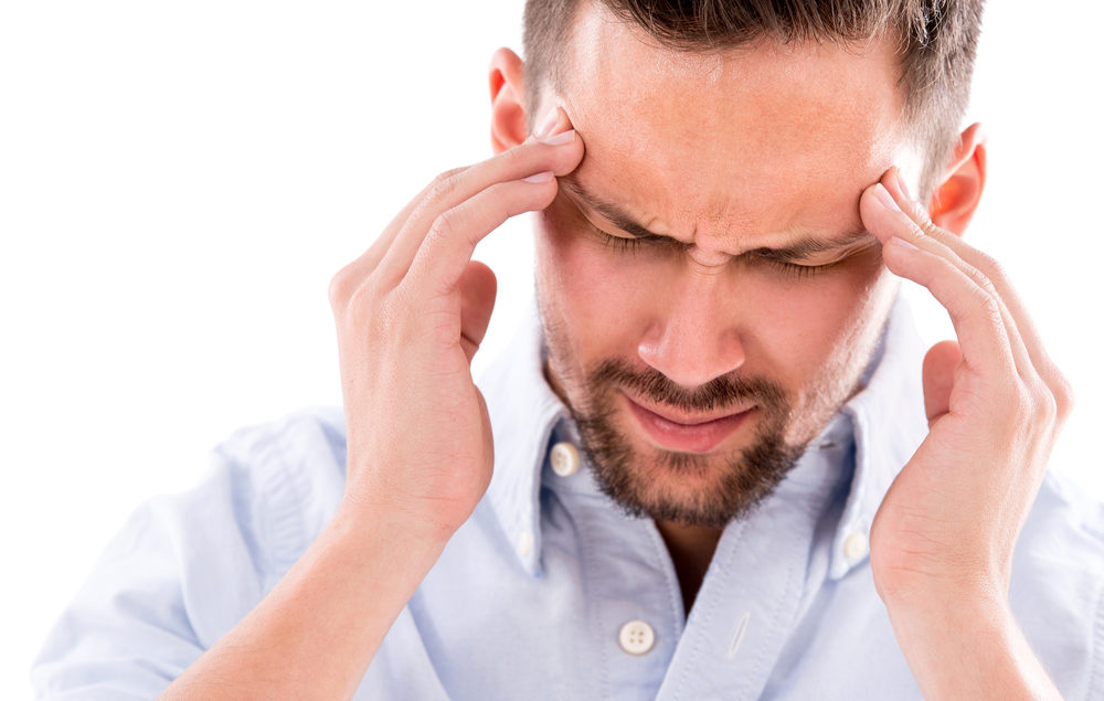 Headache After A Car Accident In Detroit: Do I Have A Case? A man holds his temples in anguish