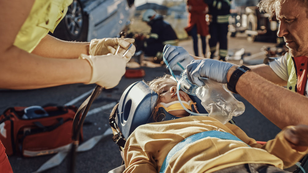 Paramedics Saving Life of a Traffic Child Accident Victim who is Lying on Stretcher