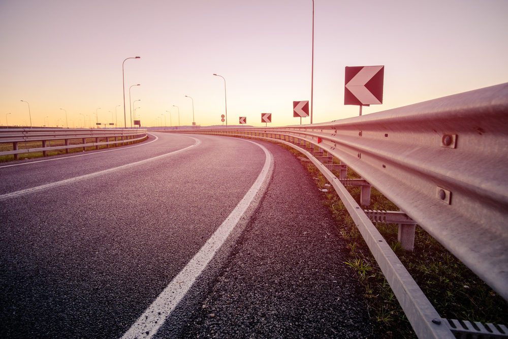 Thruway Authority Maintenance Supervisor Stephen Ebling, 58, Killed in I-90 Crash in Hanover, NY: Investigation Underway sunrise by a curved highway with guardrails