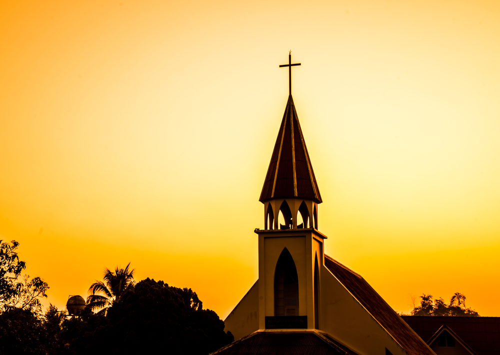 Church steeple against sunset