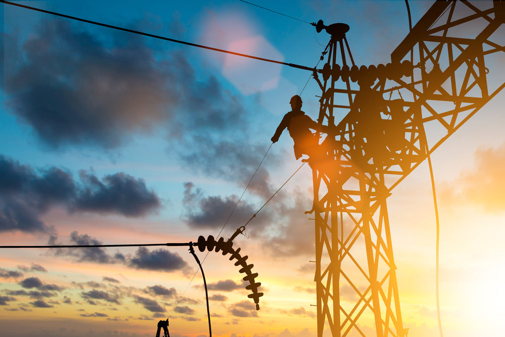 Silhouette electrician work installation of high voltage power lines