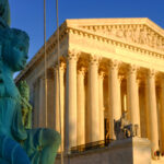 view of Supreme Court Building in Washington DC with a statue in the foreground