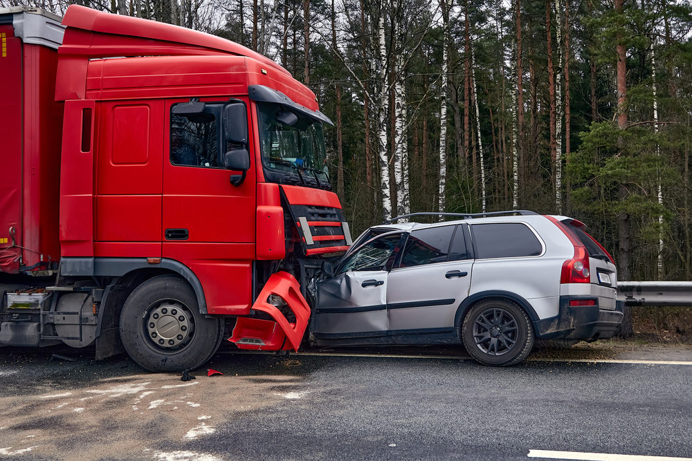 suv pinned under the front of a semi truck after an accident