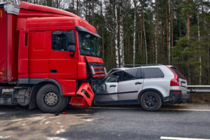 suv pinned under the front of a semi truck after an accident