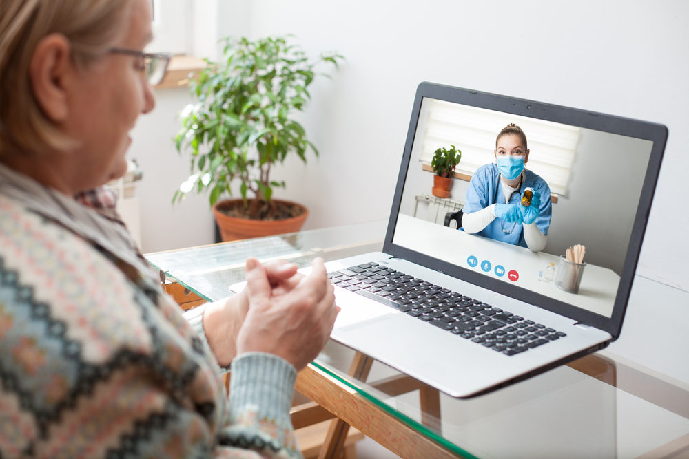 Young female doctor consulting with elderly woman over video help line virtual medical appointment chat,GP prescribing medication to senior patient,telemedicine diagnosis,therapy and treatment concept