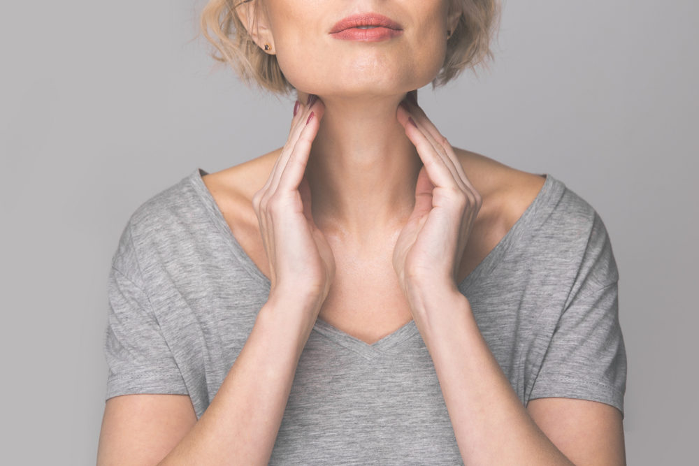 Why Is NP Thyroid Medicine Being Recalled? Female checking thyroid gland by herself.