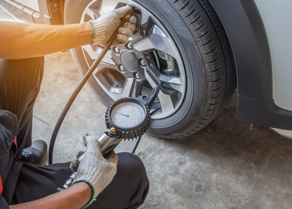 Close up air pressure gauge during mechanic inflating put air into the tyre in service station