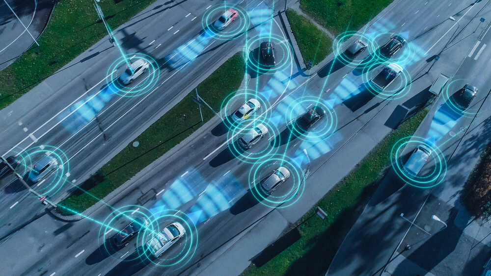 Top Down Aerial Drone: Autonomous Self Driving Cars Moving Through City. 