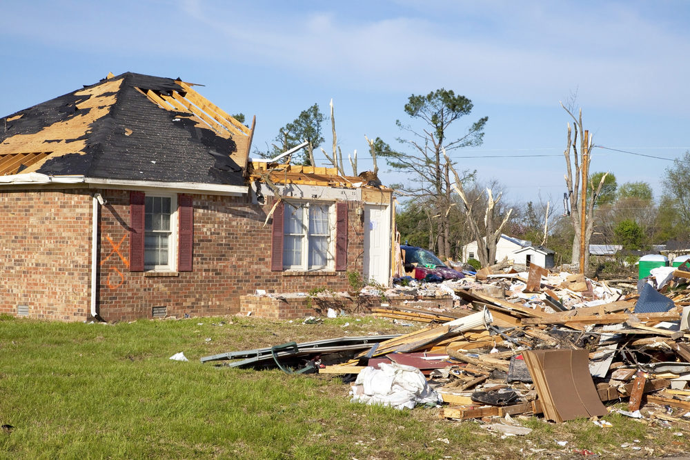 What You Need to Know About New Orleans Tornado Damage Insurance Claims home torn apart by tornado damage with debris in yard