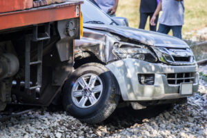 closeup of damaged car after a train collided with it on the railroad tracks