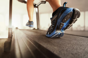 Man running in a gym on a treadmill