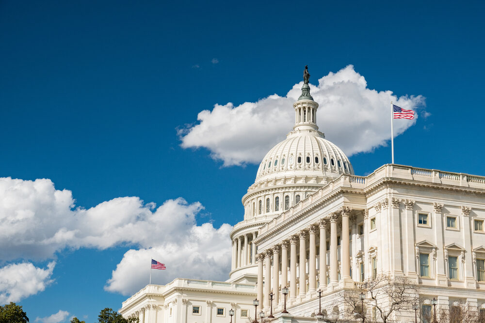 u.s. capitol building with blue skies and clouds above