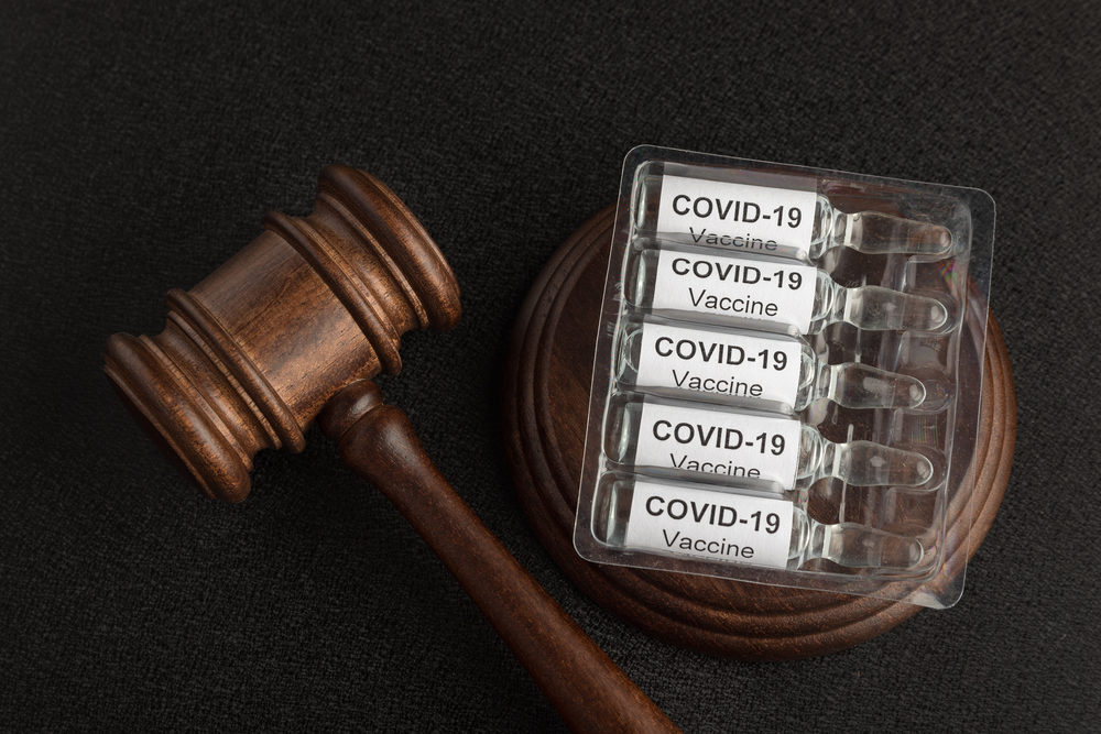 Judge gavel and ampoules with letters covid19.