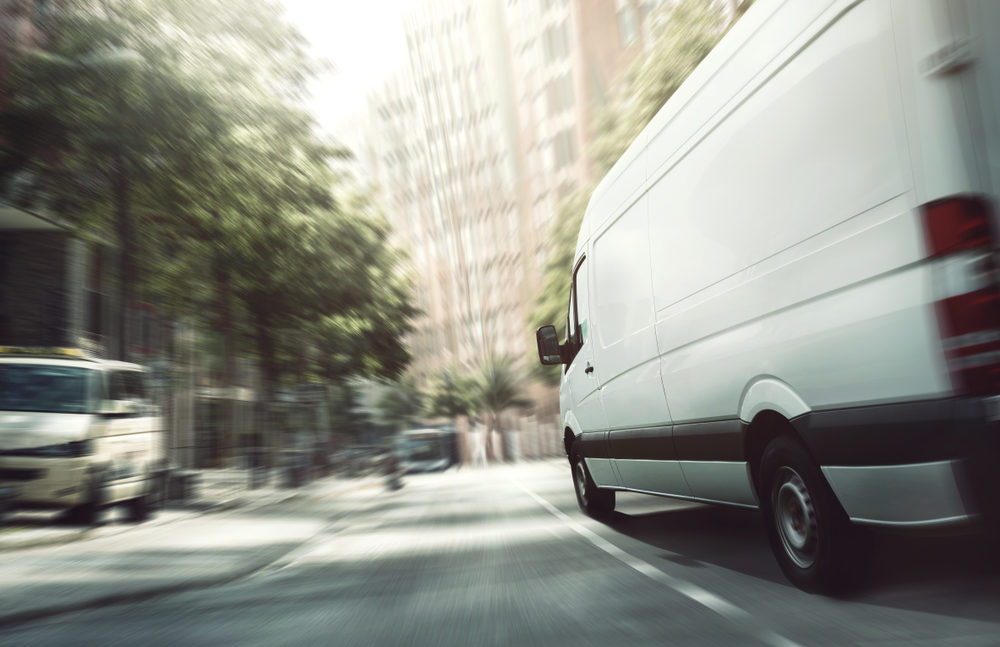 A white van driving down a city street