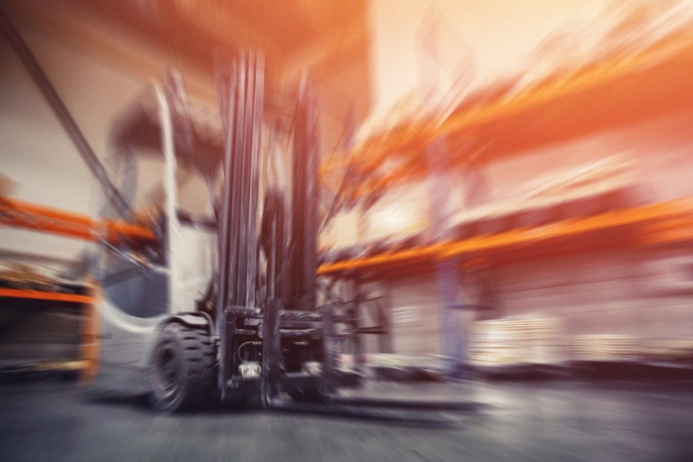 blurred forklift in a warehouse near storage racks