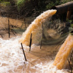 water gushing from sewer pipes